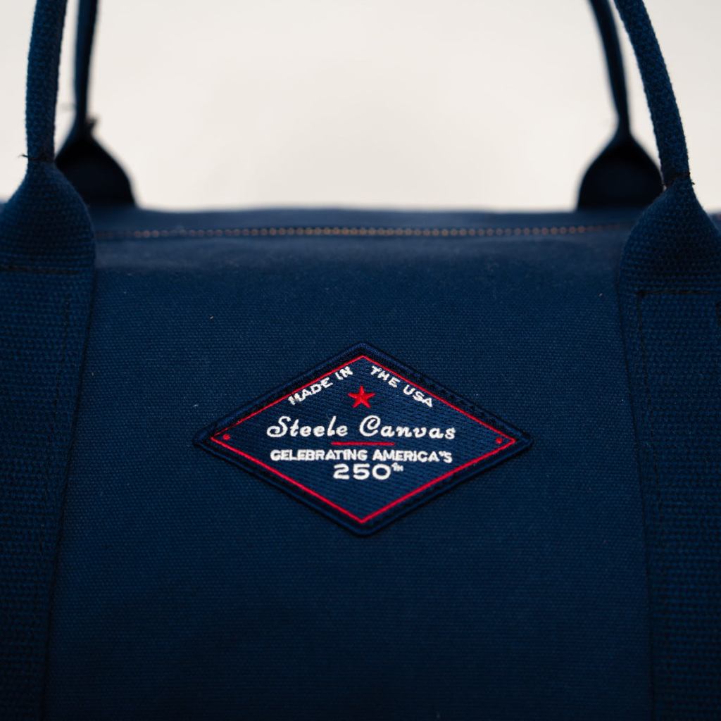 Close-up of the embroidered Made in USA Steele Canvas 250th anniversary patch on midnight-navy canvas.