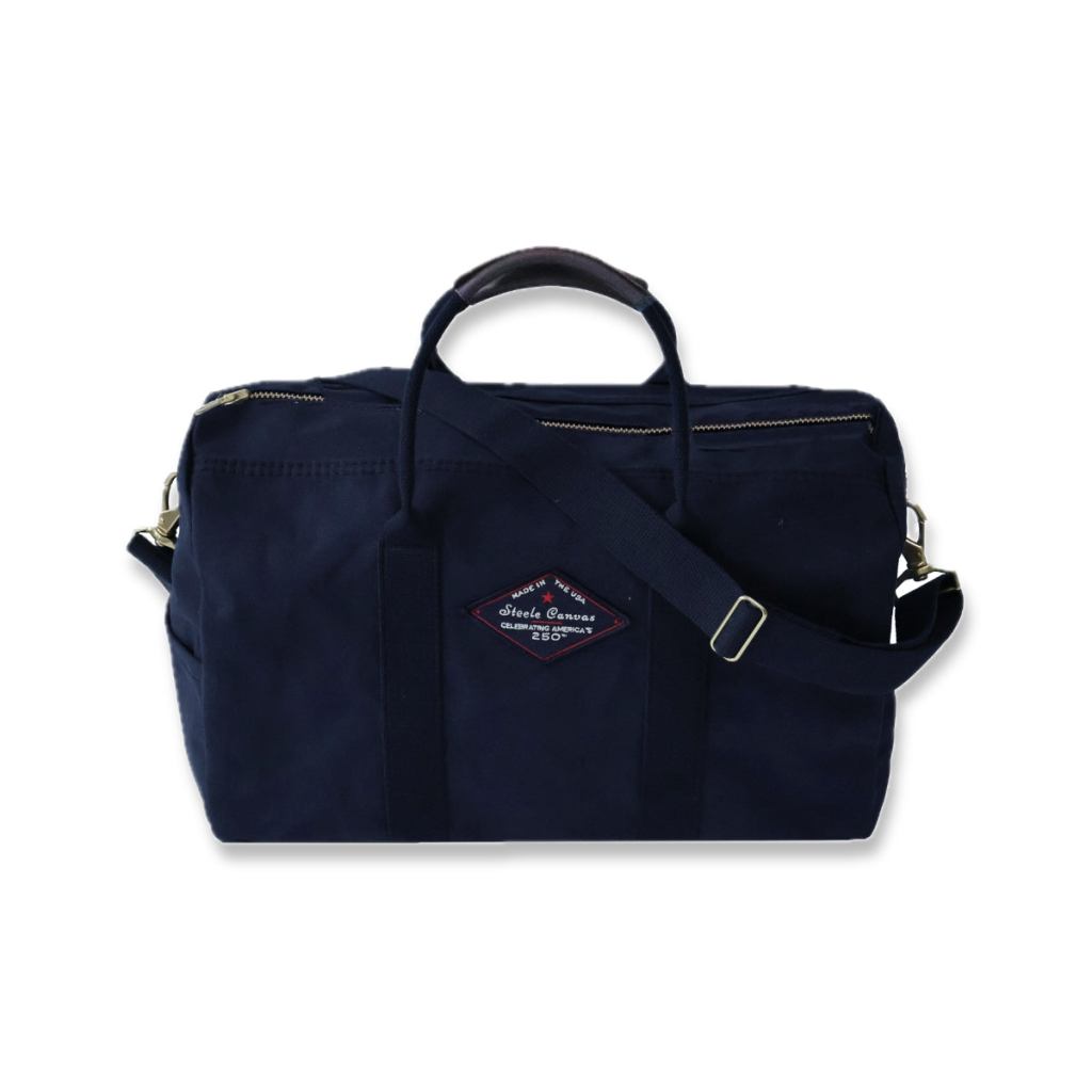 Front view of a midnight-navy Steele Canvas bag with shoulder strap and 250th anniversary patch.