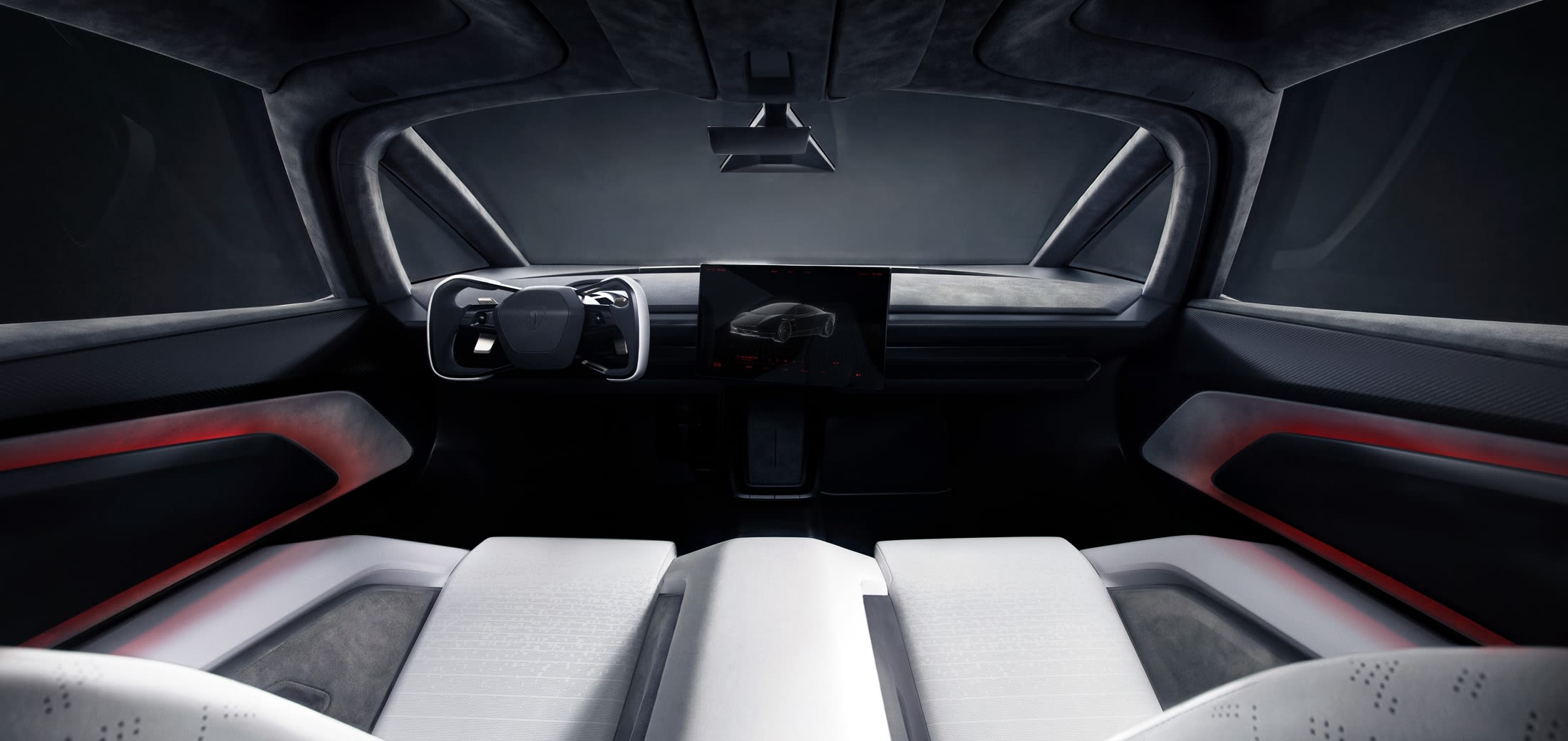 Dans l'habitacle du Roadster, deux sièges blancs font face à un volant et à un écran tactile central.